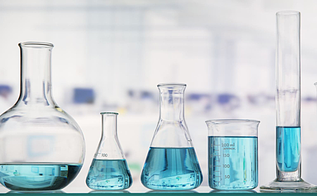 Photo of five flasks containing solutions that are uniform throughout.